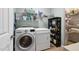 Modern laundry room featuring a washer, dryer, and storage shelves for supplies and linens at 323 Rosedale Creek Dr, Durham, NC 27703