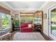 Bright and airy living room with a pink couch, large windows, and a view of the backyard at 323 Rosedale Creek Dr, Durham, NC 27703