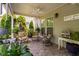 Inviting covered patio with brick flooring, ceiling fan, and comfortable seating for enjoying the outdoors at 323 Rosedale Creek Dr, Durham, NC 27703