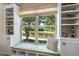 Window seat with built-in shelves and a view of a lake, great for reading or relaxation at 323 Rosedale Creek Dr, Durham, NC 27703