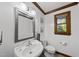 Classic half bathroom with white sink, toilet, mirror, and wood trim at 3412 Paddock Cir, Raleigh, NC 27613