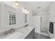 Bathroom featuring a double vanity, shower, and modern finishes at 3412 Paddock Cir, Raleigh, NC 27613
