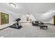 Spacious bonus room with plush carpet, ample lighting, and exercise equipment at 3412 Paddock Cir, Raleigh, NC 27613