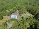 Aerial shot of community pool and tennis courts amid lush greenery, highlighting recreational options at 3412 Paddock Cir, Raleigh, NC 27613