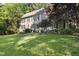 Charming two-story home featuring lush green lawns, complemented by meticulously landscaped gardens and stone features at 3412 Paddock Cir, Raleigh, NC 27613