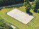Aerial view of horse arena surrounded by lush green land, showcasing outdoor equestrian space at 3412 Paddock Cir, Raleigh, NC 27613