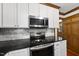 Stainless oven and microwave appliances sit above elegant granite counters at 3412 Paddock Cir, Raleigh, NC 27613