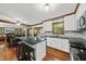Open concept kitchen with granite counters, breakfast bar, and stainless appliances at 3412 Paddock Cir, Raleigh, NC 27613