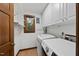 Bright laundry area with washer, dryer, cabinets and shelving at 3412 Paddock Cir, Raleigh, NC 27613