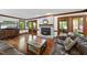 Cozy living room featuring hardwood floors, a fireplace, and access to a screened porch at 3412 Paddock Cir, Raleigh, NC 27613