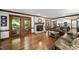 Cozy living room featuring hardwood floors, a fireplace, and access to a screened porch at 3412 Paddock Cir, Raleigh, NC 27613