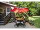 Paver patio with outdoor dining set, shade umbrella, and potted plants; a perfect spot for outdoor entertaining at 3412 Paddock Cir, Raleigh, NC 27613