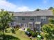 Back view of townhomes with well-maintained lawns and outdoor seating areas at 3526 Londonville Ln, Raleigh, NC 27604