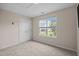 Bedroom with neutral carpet, closet with double doors and a large window with blinds at 3526 Londonville Ln, Raleigh, NC 27604