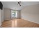 Bright, spacious bedroom with hardwood floors, ceiling fan, and a large window at 3526 Londonville Ln, Raleigh, NC 27604