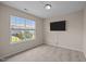 Cozy bedroom with neutral carpet, lots of natural light, and TV at 3526 Londonville Ln, Raleigh, NC 27604