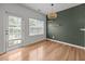 Bright dining area with hardwood floors, natural light, and modern light fixture at 3526 Londonville Ln, Raleigh, NC 27604