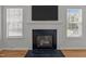 A traditional fireplace with a black surround and white mantel creating a cozy focal point at 3526 Londonville Ln, Raleigh, NC 27604