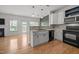 A charming kitchen featuring modern appliances, white cabinets, and an open-concept design at 3526 Londonville Ln, Raleigh, NC 27604