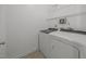 Well-lit laundry room featuring a washer and dryer, with wire rack shelving at 3526 Londonville Ln, Raleigh, NC 27604