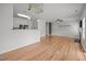 Spacious open-concept living room featuring hardwood floors, fireplace and a breakfast bar at 3526 Londonville Ln, Raleigh, NC 27604