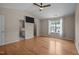 Main bedroom featuring hardwood floors, ceiling fan, and an ensuite bathroom at 3526 Londonville Ln, Raleigh, NC 27604