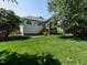 Beautiful backyard featuring lush green grass and mature trees surrounding the home at 3709 Andoversford Ct, Wake Forest, NC 27587