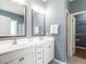 Bathroom with double sink vanity, large mirror, and access to a walk-in closet at 3709 Andoversford Ct, Wake Forest, NC 27587