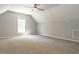 Large bonus room features neutral carpeting, a ceiling fan, and one window at 3709 Andoversford Ct, Wake Forest, NC 27587