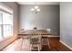 Well-lit dining area with hardwood floors, a chandelier, and table for four at 3709 Andoversford Ct, Wake Forest, NC 27587