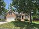 Traditional brick home with an attached two-car garage, lush landscaping, and classic shutters at 3709 Andoversford Ct, Wake Forest, NC 27587