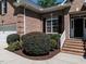 Charming brick home entrance with well-maintained landscaping and black shutters at 3709 Andoversford Ct, Wake Forest, NC 27587