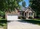 Lovely single-Gathering brick home featuring a lush front yard and attached garage at 3709 Andoversford Ct, Wake Forest, NC 27587