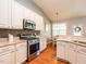 Modern kitchen featuring stainless steel appliances, stone backsplash, and a view of the dining nook at 3709 Andoversford Ct, Wake Forest, NC 27587