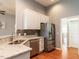 Kitchen with stainless steel appliances, granite counters, tile backsplash, sink, and hardwood floors at 3709 Andoversford Ct, Wake Forest, NC 27587