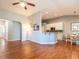 Open-concept living room showcasing hardwood floors and seamless flow into kitchen and dining area at 3709 Andoversford Ct, Wake Forest, NC 27587