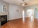 Open-concept living room with hardwood floors, a fireplace, and arched doorways at 3709 Andoversford Ct, Wake Forest, NC 27587