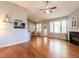 Spacious living room featuring wood floors, a fireplace, and large windows at 3709 Andoversford Ct, Wake Forest, NC 27587