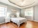 Serene main bedroom with tray ceiling, hardwood floors, and lots of natural light at 3709 Andoversford Ct, Wake Forest, NC 27587