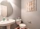 Charming powder room with pedestal sink, updated fixtures, and a decorative 'Love' wall decor at 3709 Andoversford Ct, Wake Forest, NC 27587