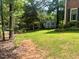 Spacious backyard with green grass and a shed, offering ample outdoor space at 408 Greenfern Ct, Burlington, NC 27215