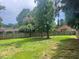 Large backyard featuring a lawn and a tall wooden fence at 408 Greenfern Ct, Burlington, NC 27215