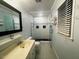 Bathroom featuring a double vanity, glass shower, tiled floors, and a window at 408 Greenfern Ct, Burlington, NC 27215