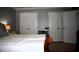 Spacious bedroom with multiple closets and a queen bed against gray walls at 408 Greenfern Ct, Burlington, NC 27215
