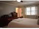 Bedroom featuring a full size bed, crown molding, a large dresser, and a window with natural light at 408 Greenfern Ct, Burlington, NC 27215