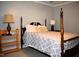 Bedroom featuring a four poster bed, neutral walls, and cozy bedding at 408 Greenfern Ct, Burlington, NC 27215