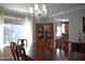 Elegant dining room showcasing a chandelier, hardwood table, and natural light at 408 Greenfern Ct, Burlington, NC 27215