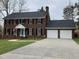 Charming brick two-story home with a spacious driveway and a two-car garage at 408 Greenfern Ct, Burlington, NC 27215