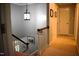 Upstairs hallway with carpet, and wood railing at 408 Greenfern Ct, Burlington, NC 27215