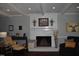 Cozy living room with a white brick fireplace and exposed beams, perfect for gatherings at 408 Greenfern Ct, Burlington, NC 27215
